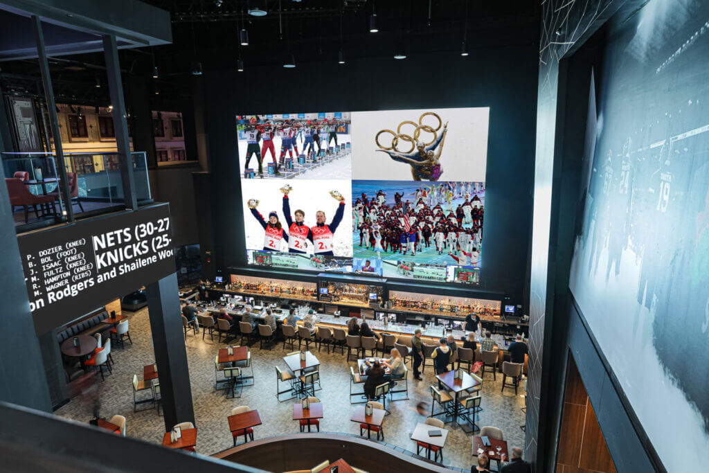 Overhead view of the Winter Olympics shown on the jumbo video wall at Draft Kings Sportsbook.