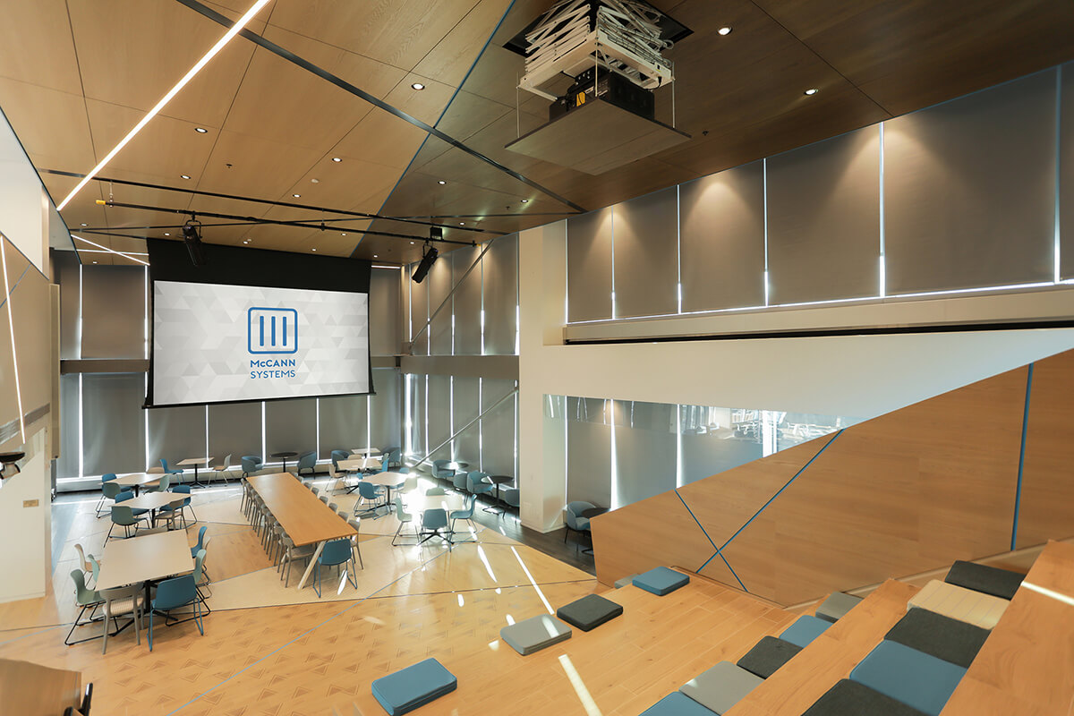 Large modern conference hall with jumbo video screen located in Kendall Square.