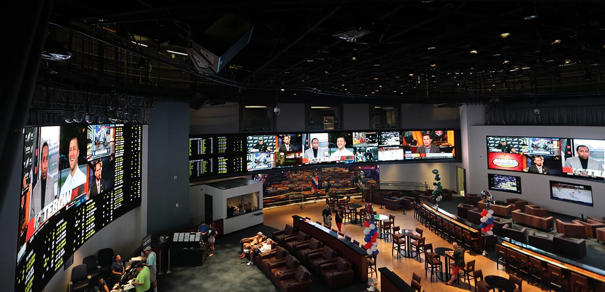 Overhead view of the Ocean City Casino sportsbook in Atlantic City including the bar and multiple video walls.