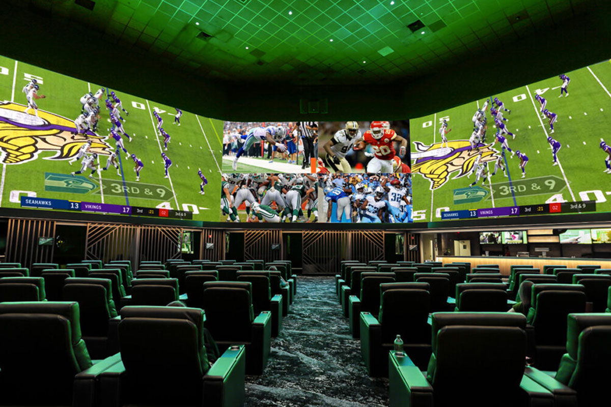Comfortable seating and large flatscreens displaying football games at the Wild Wild West Casino sportsbook in Atlantic City.