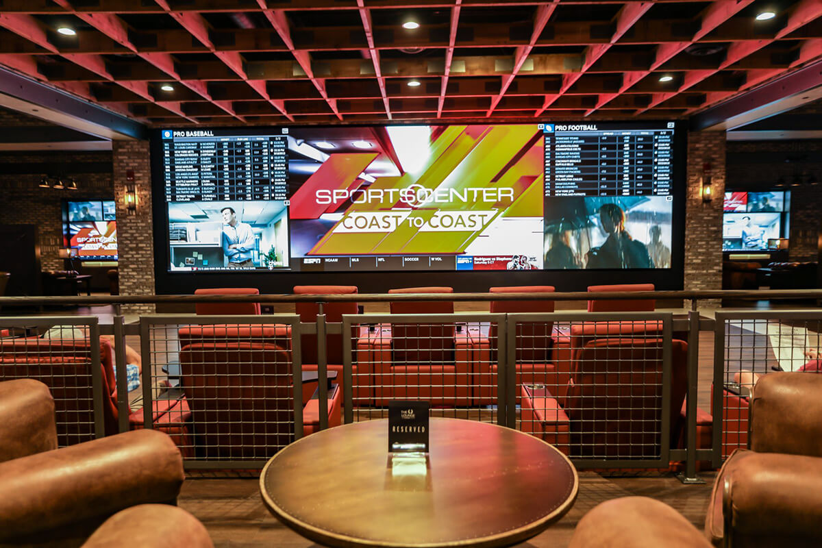 Leather chairs positioned in front of the video wall at the Yellow Brick Road Casino and Sportsbook in Chittenango, NY.