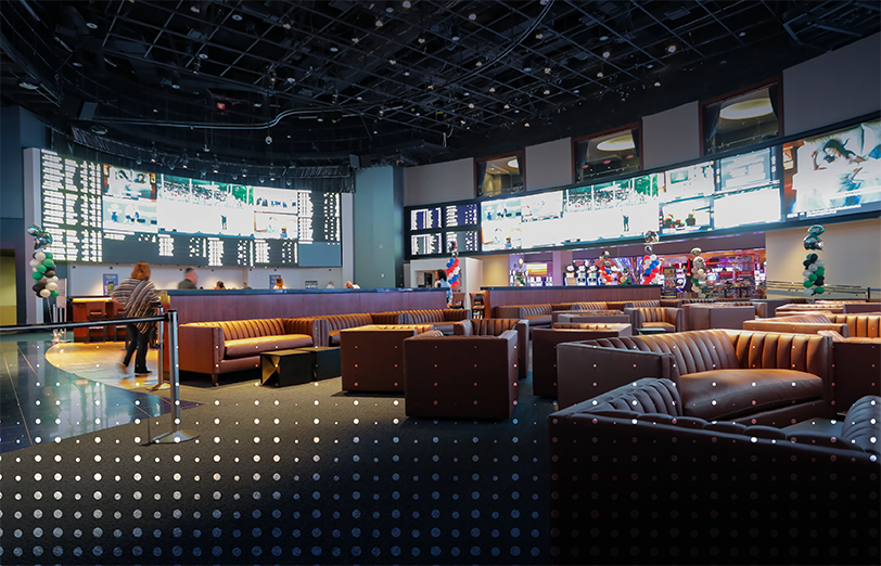 Sofas, bar and video screens at sportsbook.