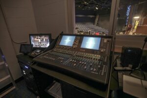 A theater with a virtual event production system in an AV room.