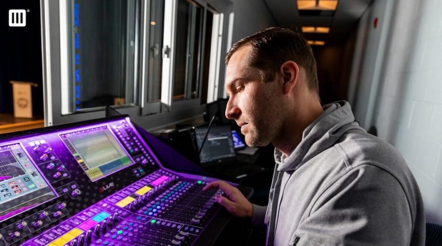 An AV technician works at a console on a client site in Ft. Worth.