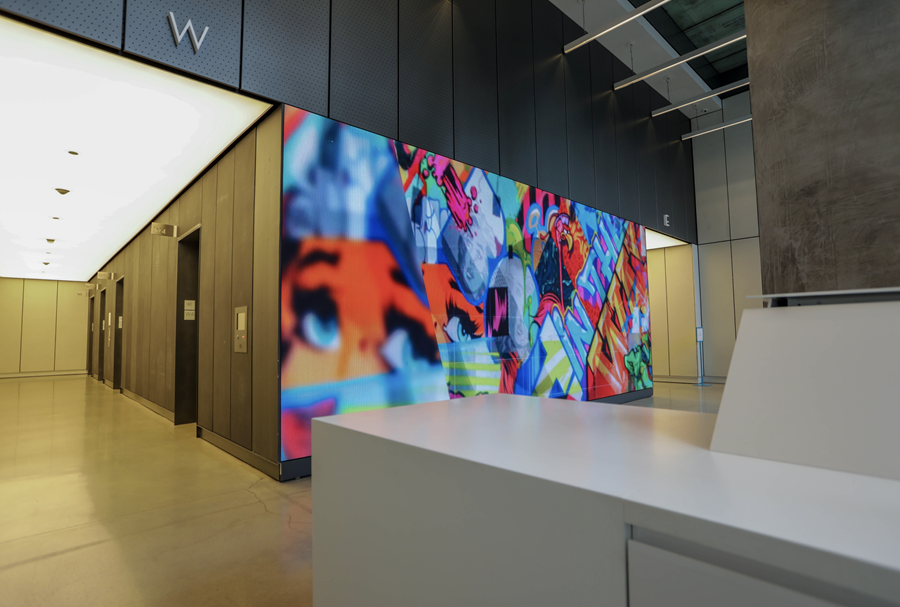 A corporate lobby leverages rotating content on an LED Video Wall showcasing abstract art.