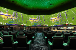 A sportsbook installation installed and supported by McCann Systems AV technicians in New Jersey featuring a large video wall and plush theater-style seating.