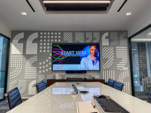 A large training and conferencing room with AV equipment in a modern hospital.