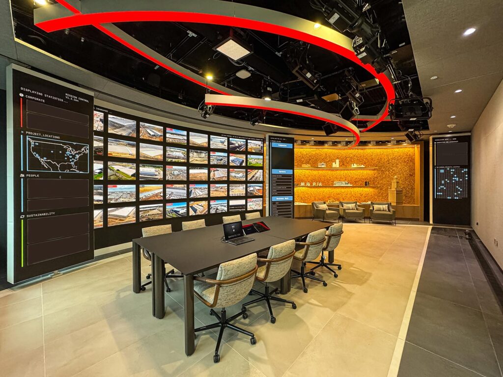 High-tech customer experience center with large video wall and modern seating