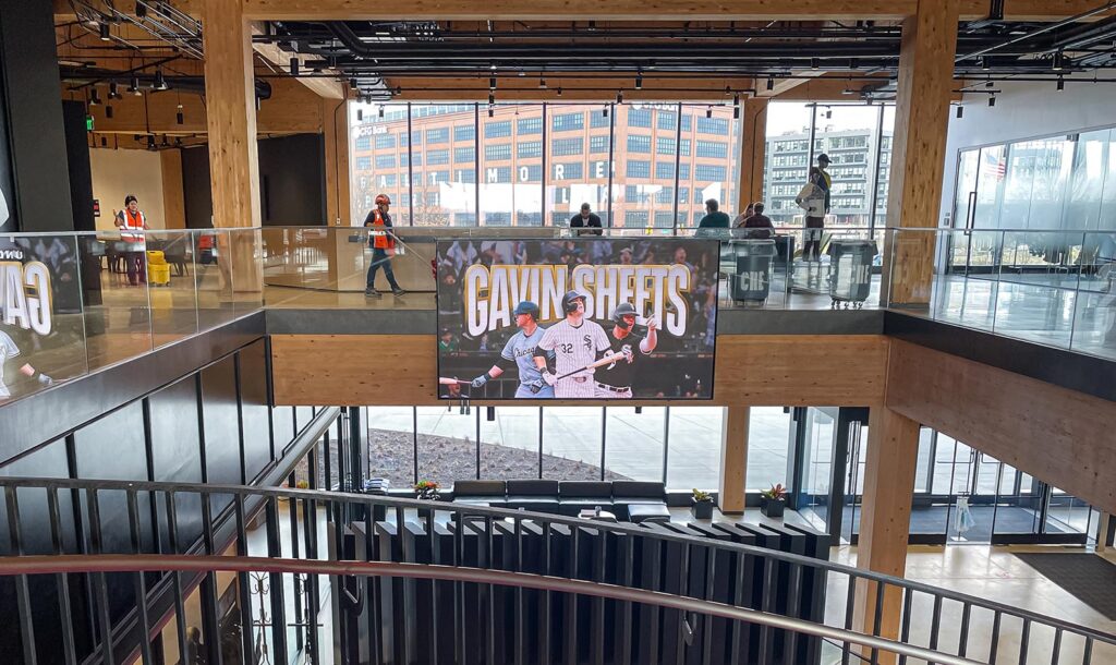 Large lobby with screen showing Gavin Sheets and wood architectural details