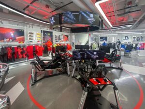 The PUMA flagship store in Las Vegas with an interactive F1 simulator below a circular spectator display.