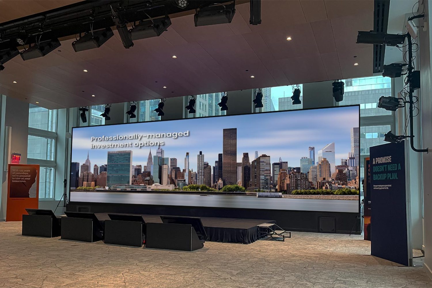 High-resolution LED screen displaying a city skyline in a contemporary presentation space.