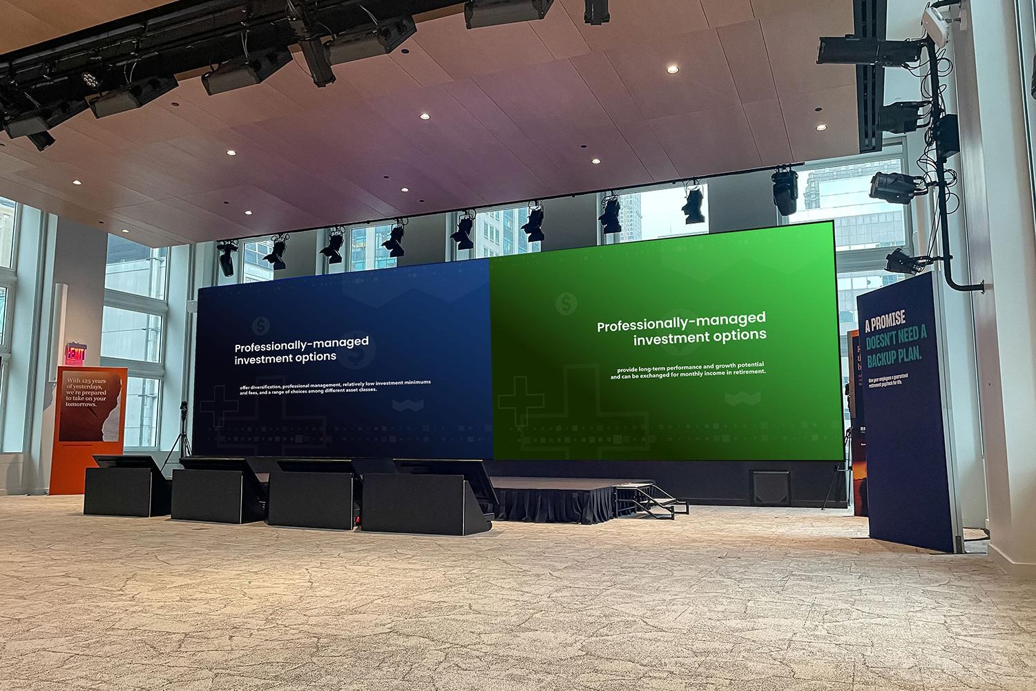 Wide-angle view of a modern corporate auditorium with an immersive display setup.