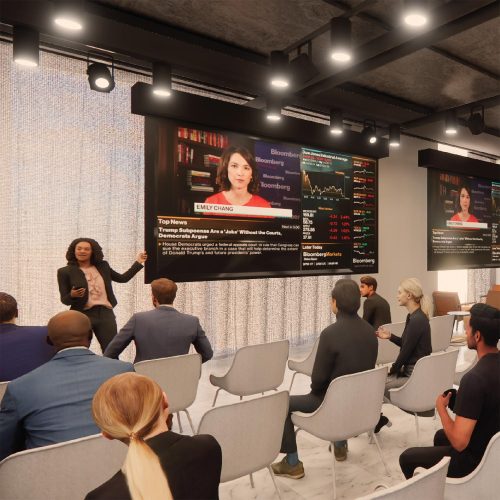 Design-Consulting-Topic-1 Presenter speaking to an audience with live Bloomberg news feed on large displays