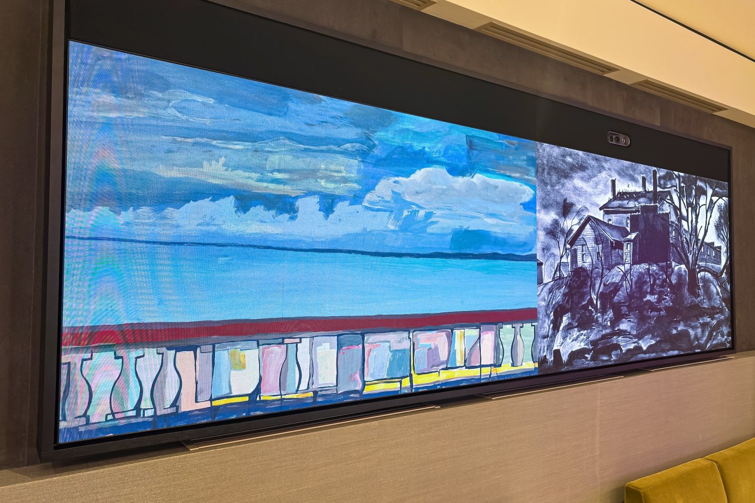 A close-up of one of the large video walls in the boardroom, displaying a combination of digital artwork and monochrome imagery. The integration of AV technology elevates the executive meeting experience.