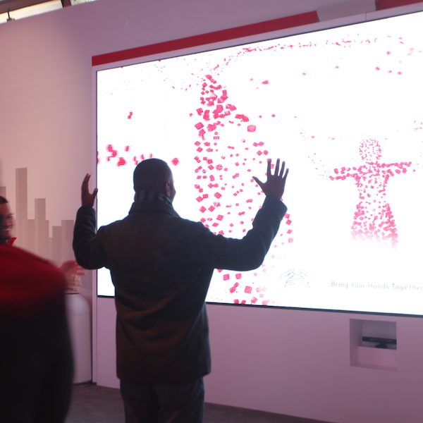 MCCSYS_AprilBlog2_AVSystemDesign)New Jersey_PRO_PHOTO A man standing in front of a projector screen that shows his body’s heat signature.