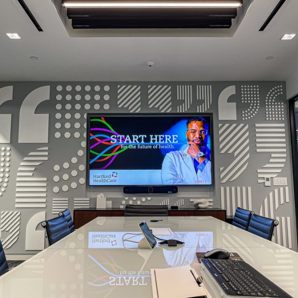 A large training and conferencing room with AV equipment in a modern hospital.