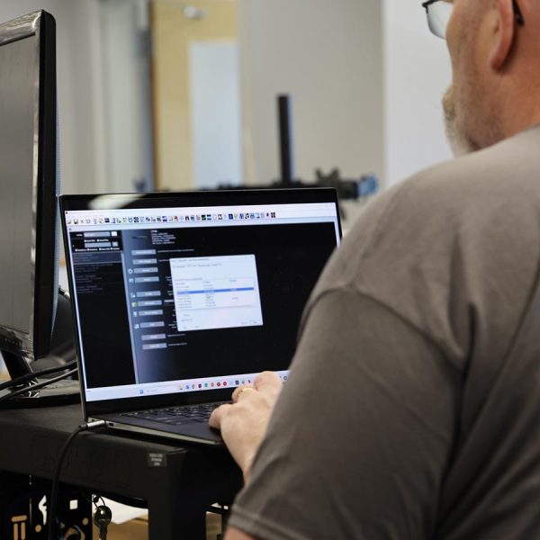 cta-design-consult Man using a laptop with configuration software on screen