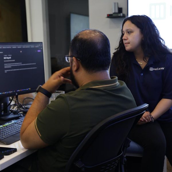 cta-healthcare Two colleagues discussing a project at a computer workstation in an office setting