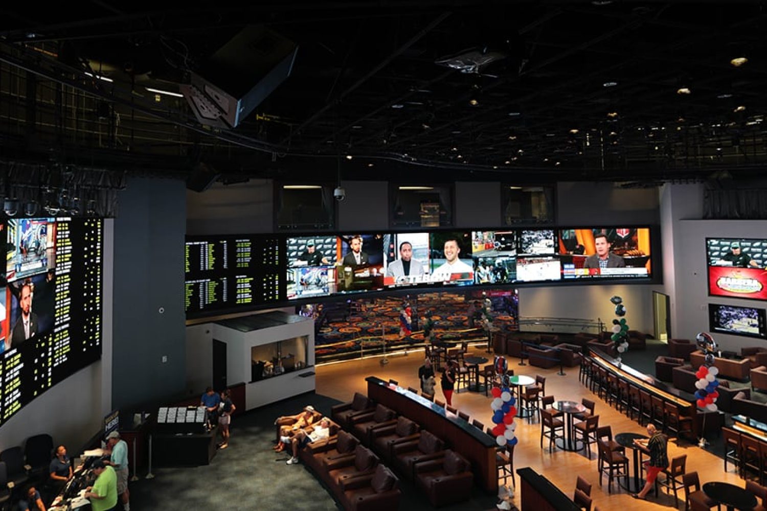 Overhead view of the Ocean City Casino sportsbook in Atlantic City including the bar and multiple video walls.